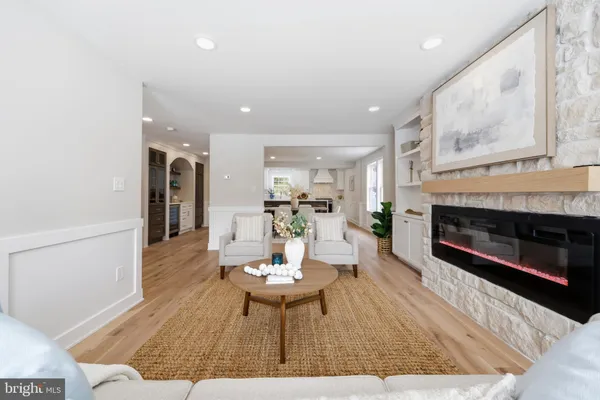 a living room with a fireplace and a wooden floor