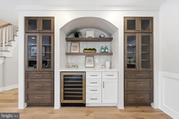 a kitchen with granite countertop a sink a stove a dining table and chairs