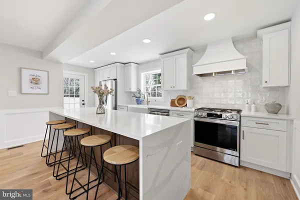 a large kitchen with a table and chairs