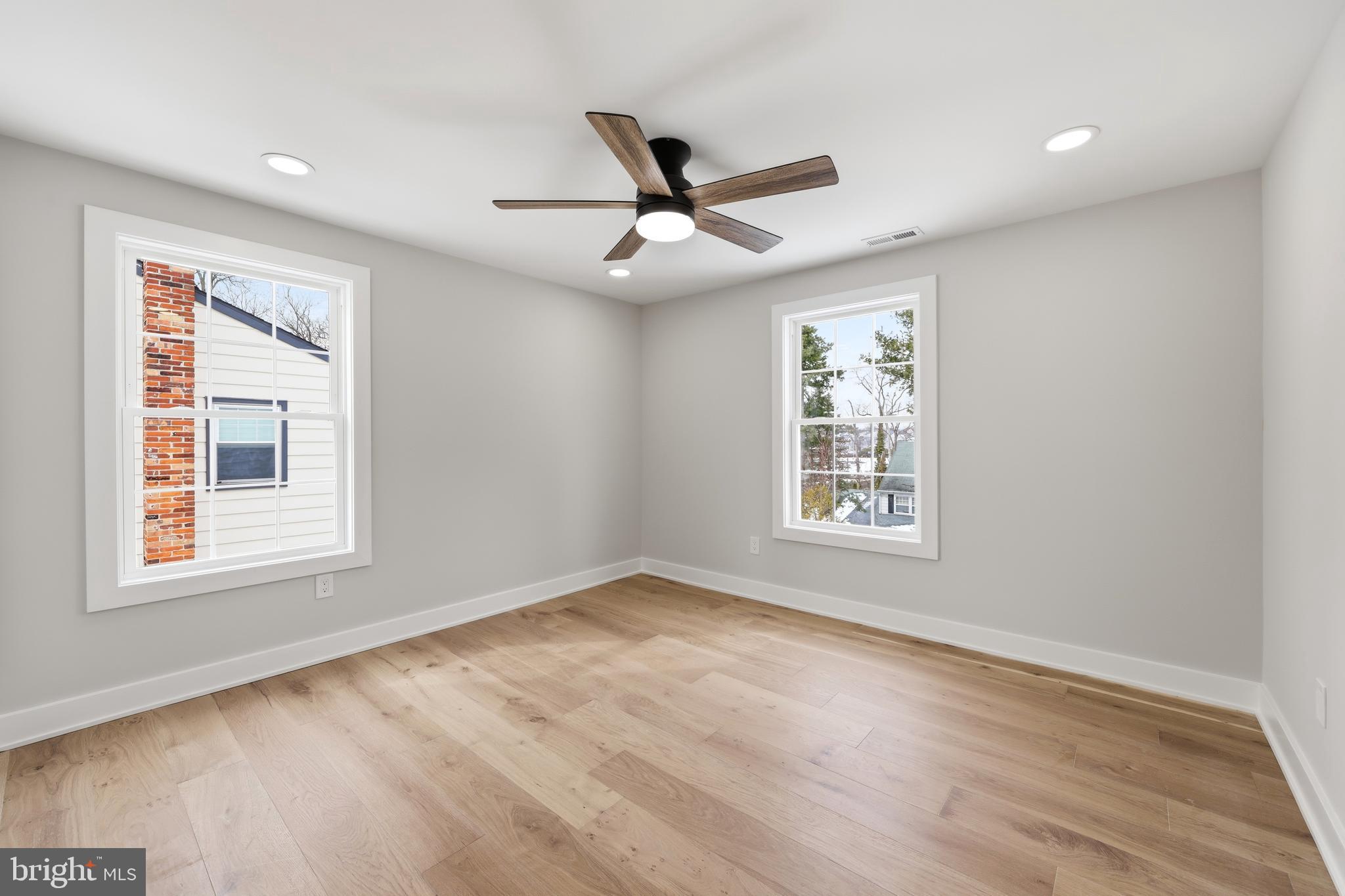 615 Pardee Lane Haddonfield, NJ 08033 - Photo 30 of 37 an empty room with wooden floor ceiling fan and windows