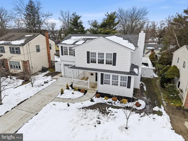 a view of a white house with a yard