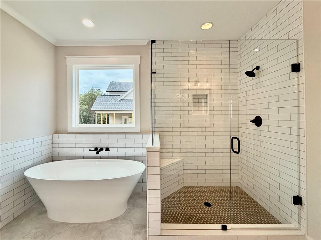 141 Palisade Drive Rydal, GA 30171 - Photo 26 of 50 a bathroom with a tub a window and a shower