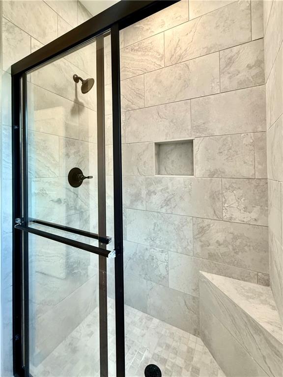 141 Palisade Drive Rydal, GA 30171 - Photo 35 of 50 a bathroom with a glass shower door