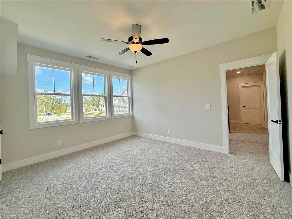 141 Palisade Drive Rydal, GA 30171 - Photo 43 of 50 an empty room with windows and ceiling fan view
