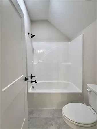 a bathroom with a granite countertop sink a toilet and a bathtub