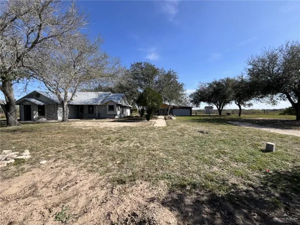 a front view of a building with a yard