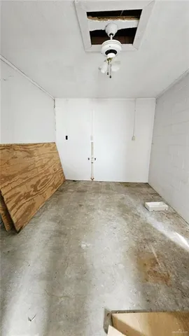 a view of a room with a ceiling fan