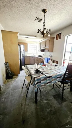 a living room with dining table and a window