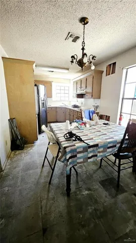 a living room with dining table and a window