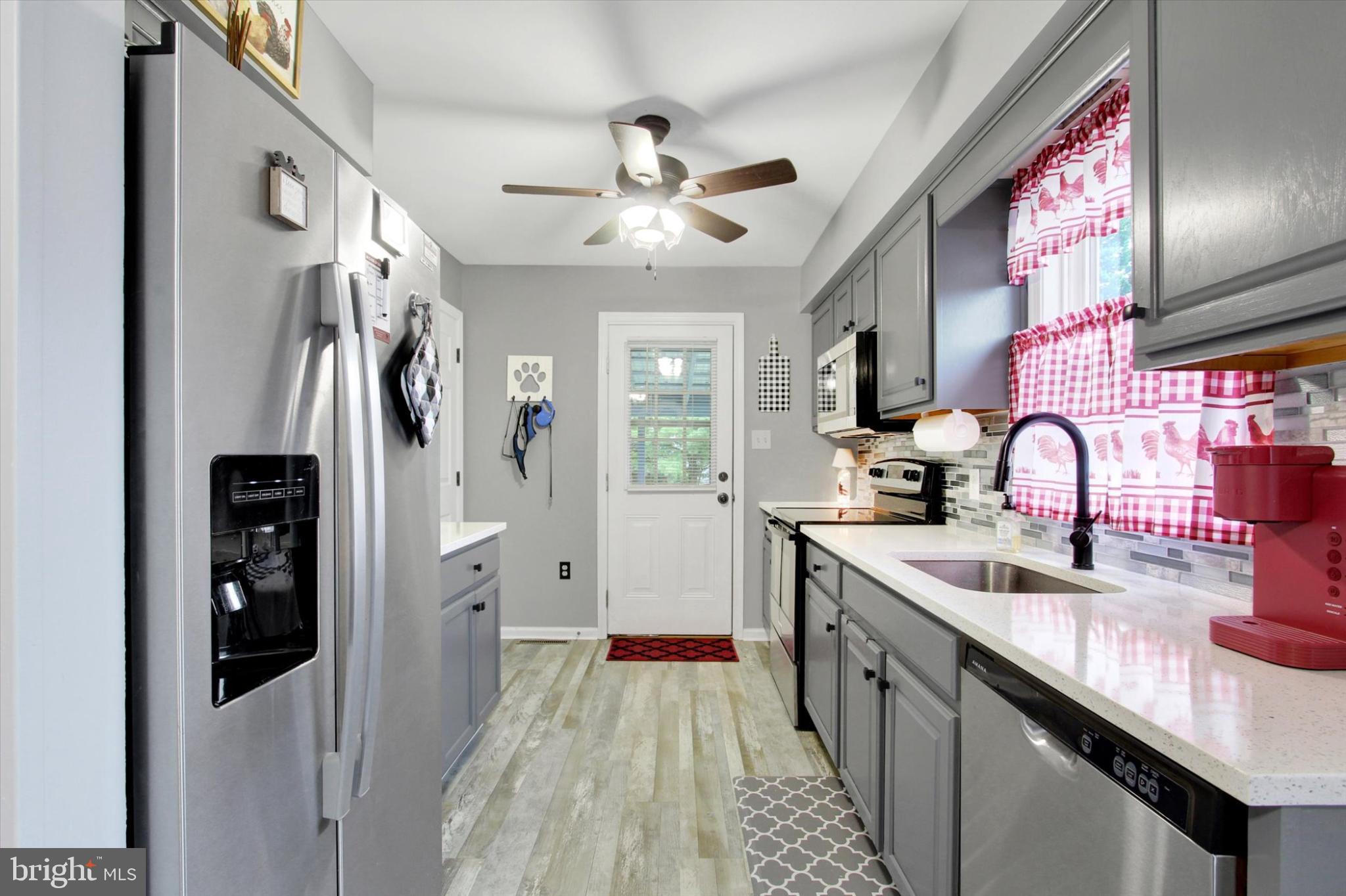 1484 Fire Hall Road Spring Grove, PA 17362 - Photo 7 of 19 a kitchen with stainless steel appliances granite countertop a sink stove and refrigerator