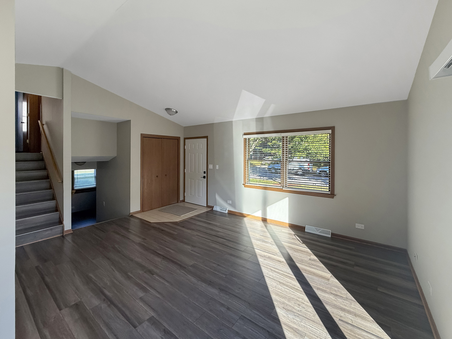 139 Spuhler Drive, Unit 139 Batavia, IL 60510 - Photo 5 of 12 a view of an empty room with wooden floor and a window