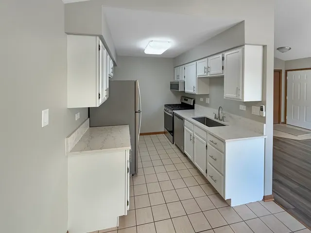 a kitchen with stainless steel appliances a refrigerator and a stove