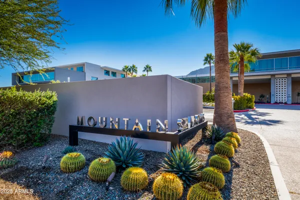 a front view of house with a garden and patio