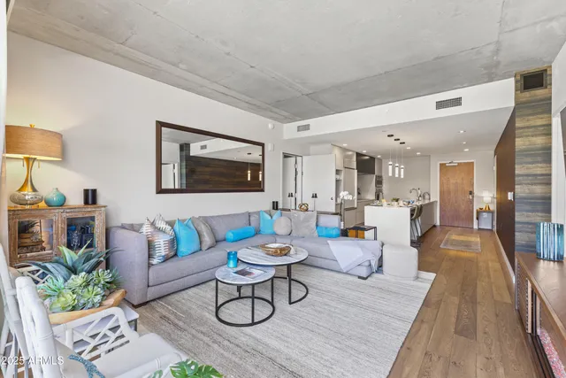 a living room with furniture and a wooden floor