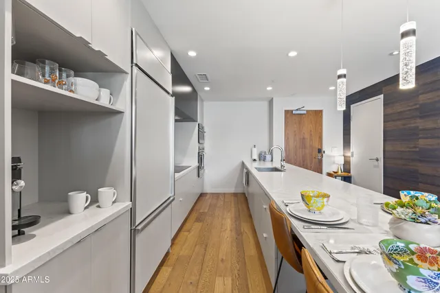 a dining room with stainless steel appliances a table and chairs