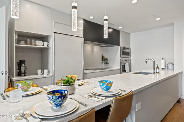 a kitchen with a dining table and chairs