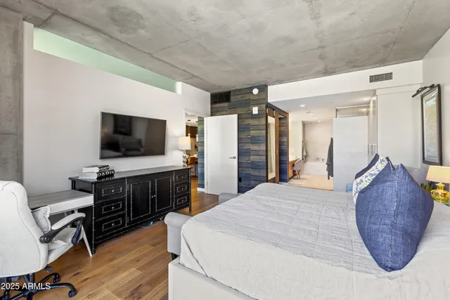 a bedroom with furniture and a flat screen tv