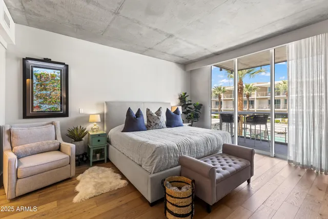 a spacious bedroom with a bed and a couch