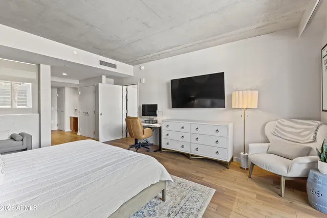 a bedroom with a bed and flat screen tv