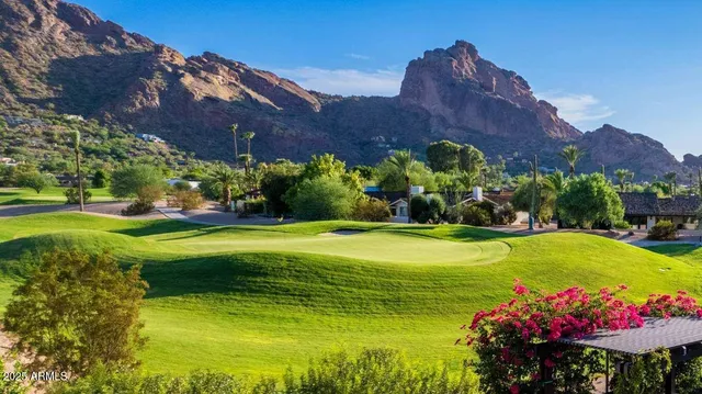a view of a house with a big yard and garden