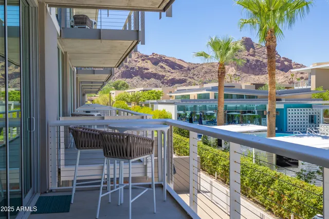 a view of a chairs and table in the balcony