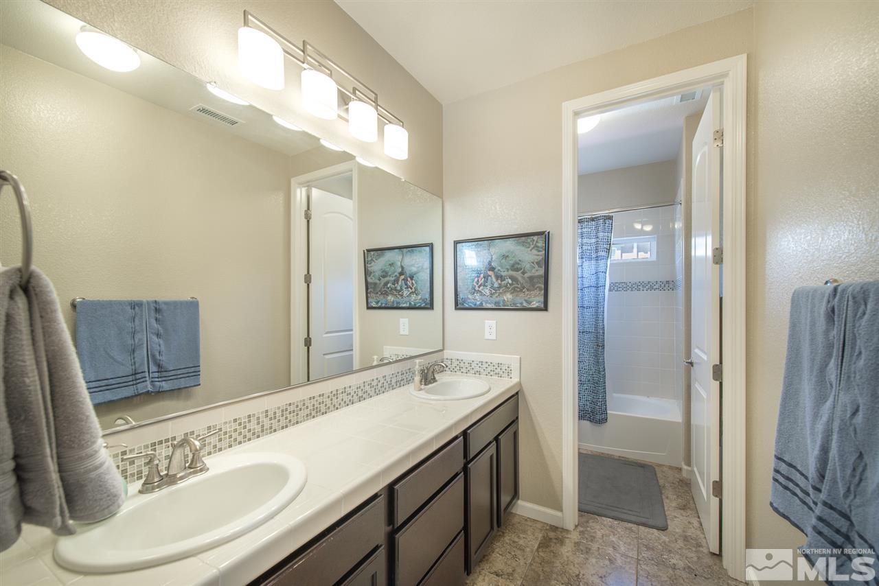 1623 Crescent Pointe Way Reno, NV 89523 - Photo 5 of 24 a bathroom with a sink and mirror with toilet