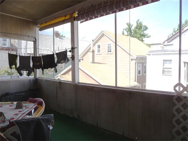 78 Spring Street Cambridge, MA 02141 - Photo 4 of 23 a view of a living room with a floor to ceiling window and wooden floor