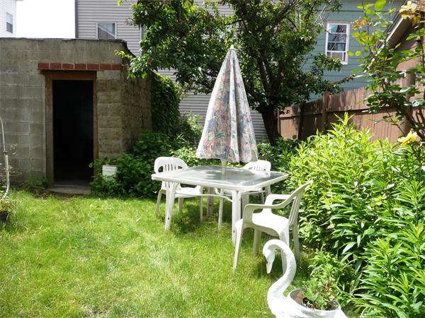 78 Spring Street Cambridge, MA 02141 - Photo 5 of 23 a view of a chair and table in backyard of the house