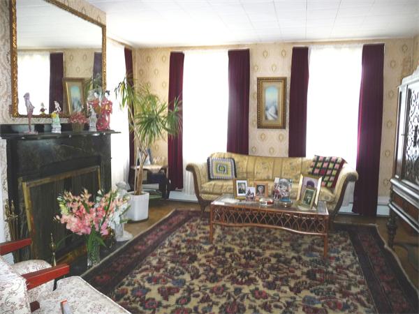 78 Spring Street Cambridge, MA 02141 - Photo 8 of 23 a living room with furniture rug and a fireplace