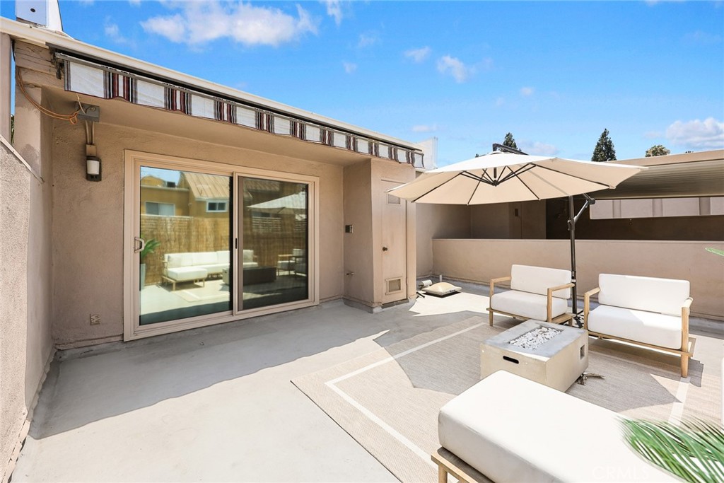 591 Fairview Avenue Arcadia, CA 91007 - Photo 12 of 20 a patio with a table and chairs under an umbrella
