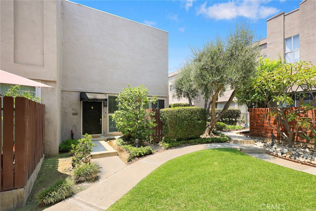 591 Fairview Avenue Arcadia, CA 91007 - Photo 3 of 20 a view of a backyard with potted plants and a large tree