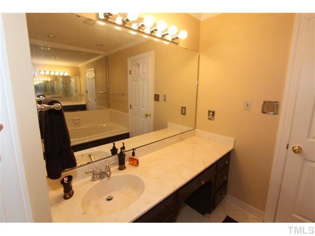 12016 Deer Run Raleigh, NC 27614 - Photo 12 of 23 a bathroom with a sink vanity and a mirror