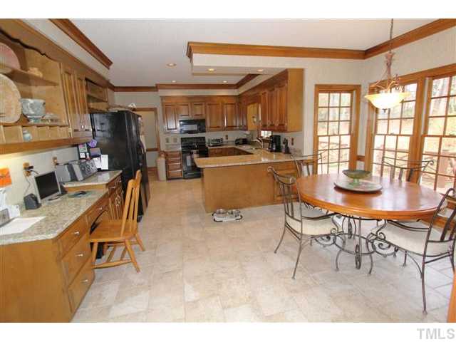 12016 Deer Run Raleigh, NC 27614 - Photo 5 of 23 a dining room with furniture a kitchen view and a window