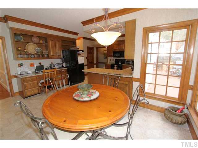 12016 Deer Run Raleigh, NC 27614 - Photo 7 of 23 a dining room with furniture a window and kitchen view