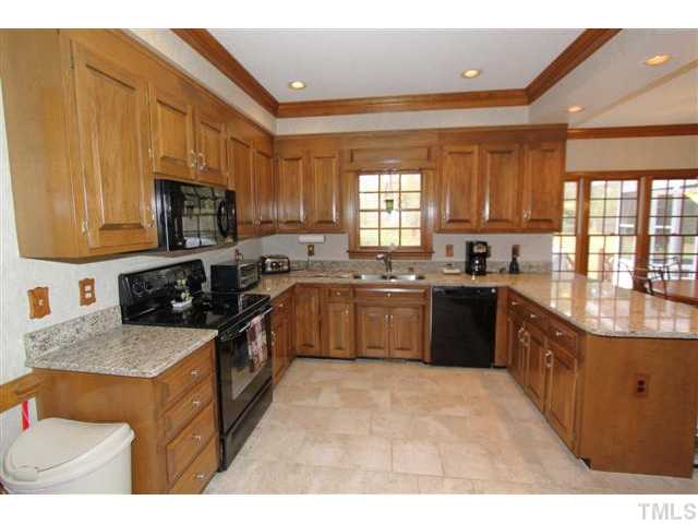 12016 Deer Run Raleigh, NC 27614 - Photo 9 of 23 a kitchen with a sink a stove top oven a sink and a window