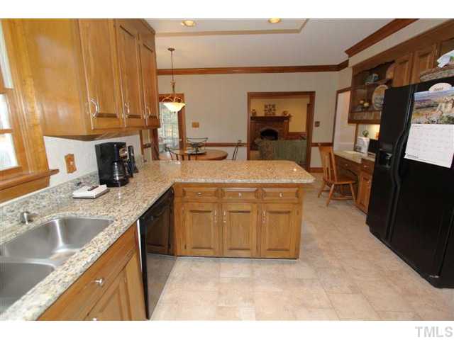 12016 Deer Run Raleigh, NC 27614 - Photo 10 of 23 a kitchen with a sink and cabinets