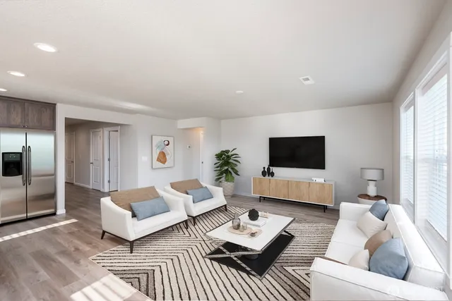 a living room with furniture a flat screen tv and a large window