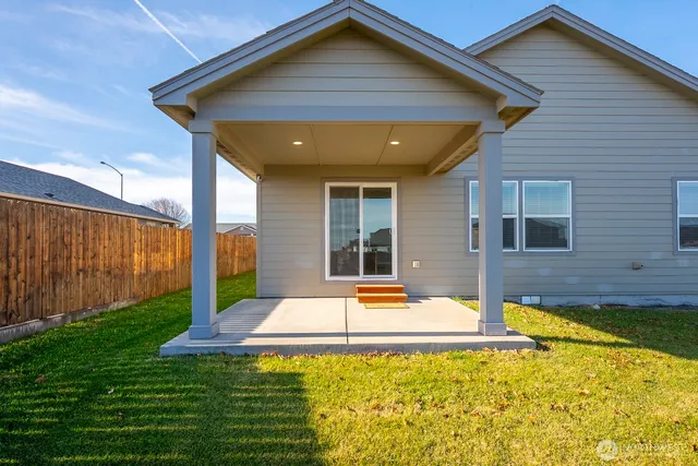 a view of a house with backyard and swimming pool