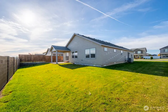 a view of a house with backyard and sitting area