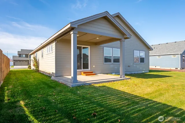 a view of a backyard with plants and a garden