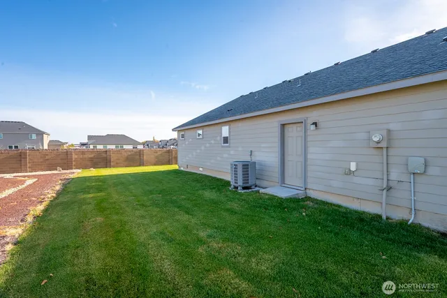 an aerial view of a swimming pool with a lawn chairs and swimming pool