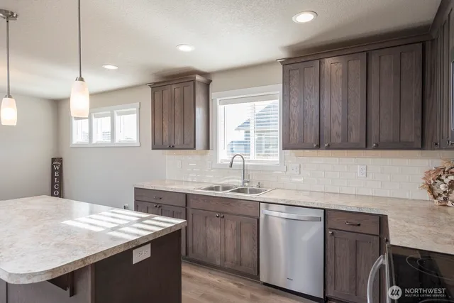 a kitchen with a sink cabinets and window