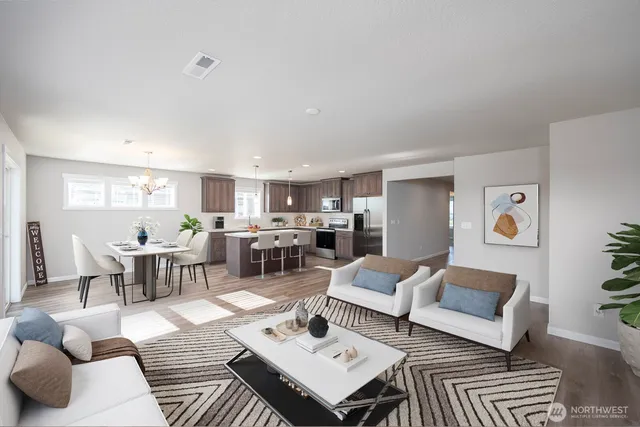 a living room with lots of furniture and view of kitchen