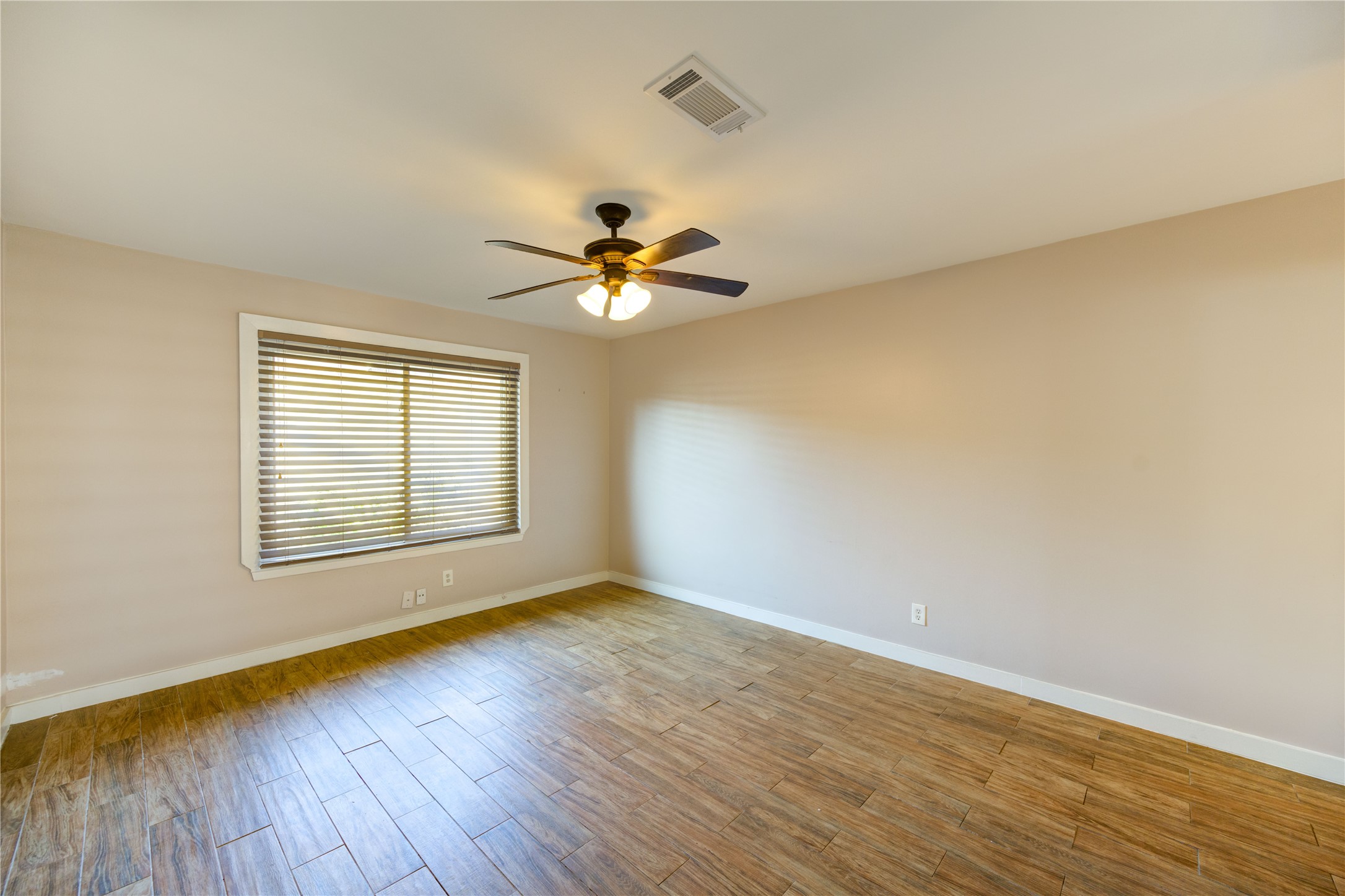 12339 South Dairy Ashford Road, Unit 2339 Houston, TX 77099 - Photo 14 of 19 a view of an empty room with wooden floor and a window