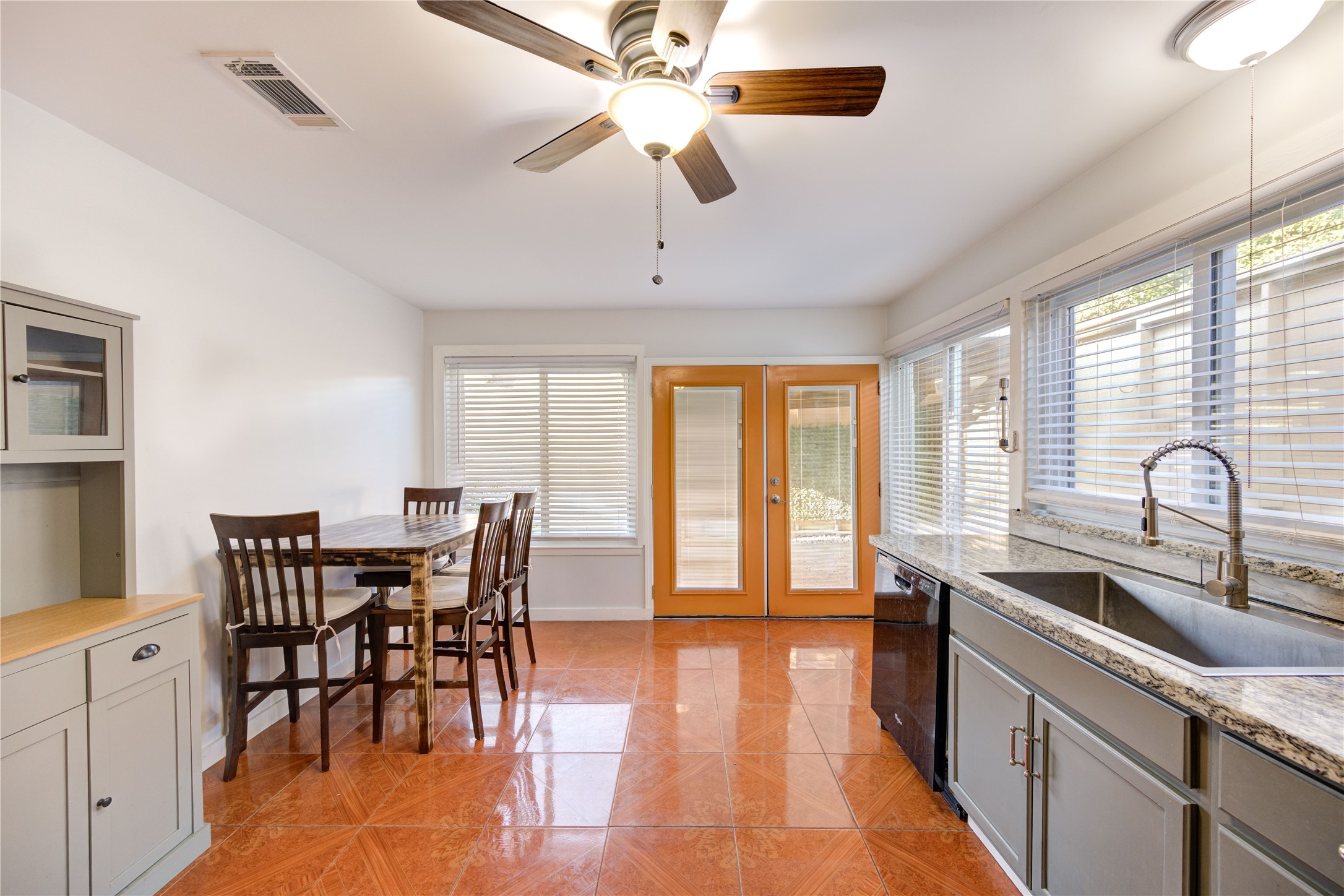 12339 South Dairy Ashford Road, Unit 2339 Houston, TX 77099 - Photo 8 of 19 a kitchen with stainless steel appliances granite countertop a stove a sink a dining table and chairs with wooden floor