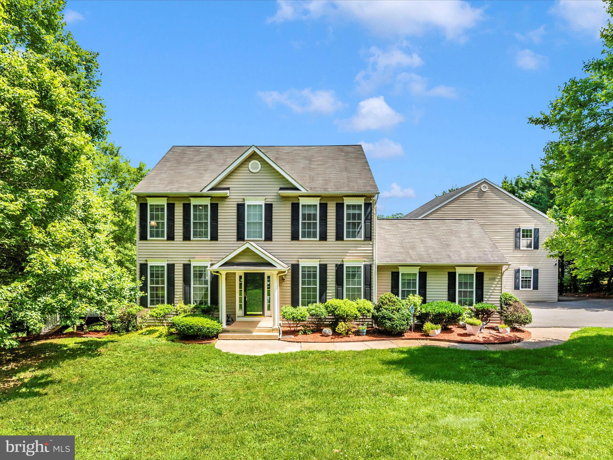 a front view of a house with garden and porch