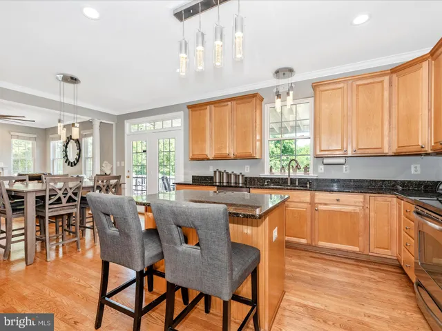 a kitchen with stainless steel appliances granite countertop a sink a stove and a microwave