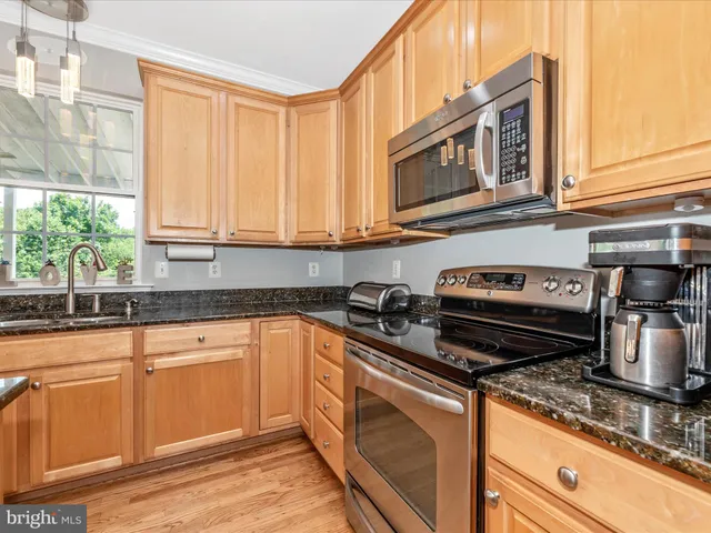 a living room with fireplace furniture and a large window