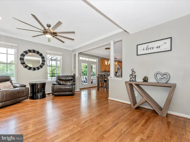 a bedroom with a bed a mirror and a large window