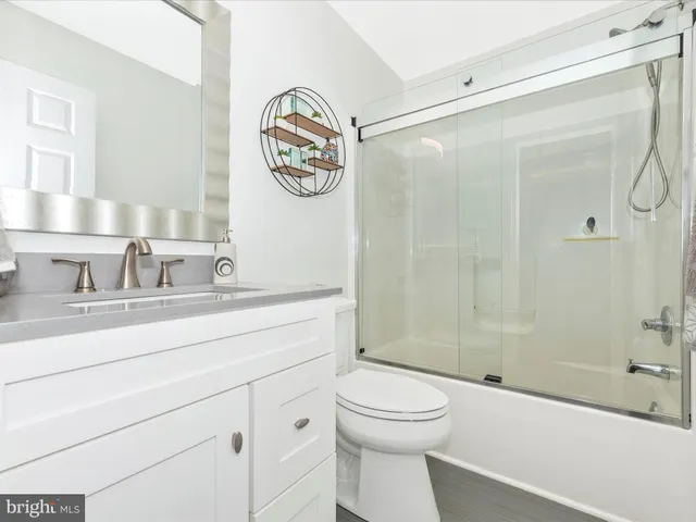 a living room with furniture a air conditioner and a table